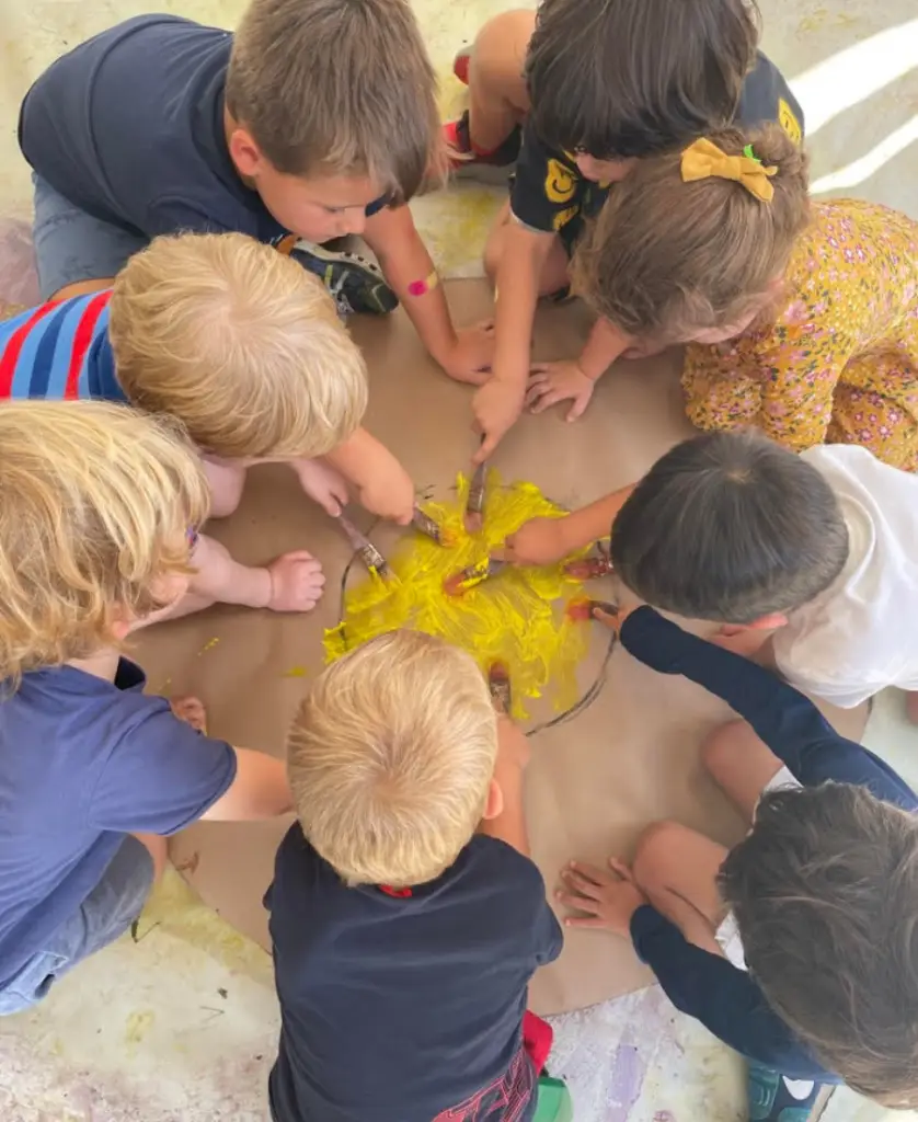 Children painting in a circle